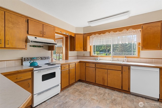 735 Coal Creek Rd, Chehalis, WA 98532 - kitchen featuring white appliances, under cabinet range hood, light countertops, and stone finish flooring