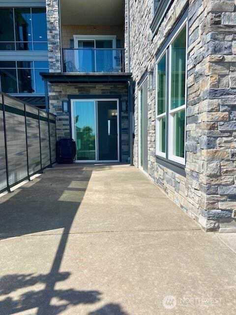 5105 Grand Loop Unit 107, Tacoma, WA 98407 - entrance to property with stone siding and a balcony