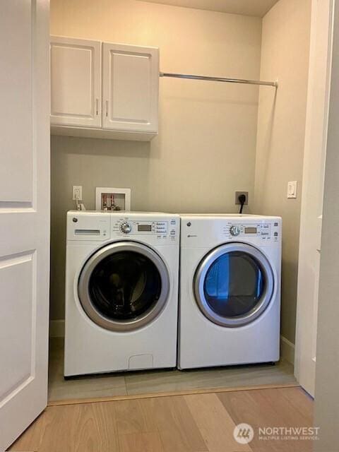 5105 Grand Loop Unit 107, Tacoma, WA 98407 - washroom with cabinet space and washing machine and clothes dryer