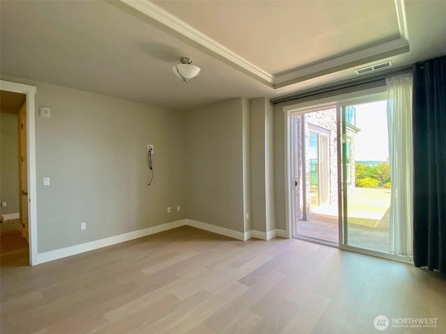 5105 Grand Loop Unit 107, Tacoma, WA 98407 - empty room featuring light wood-type flooring, a tray ceiling, and baseboards