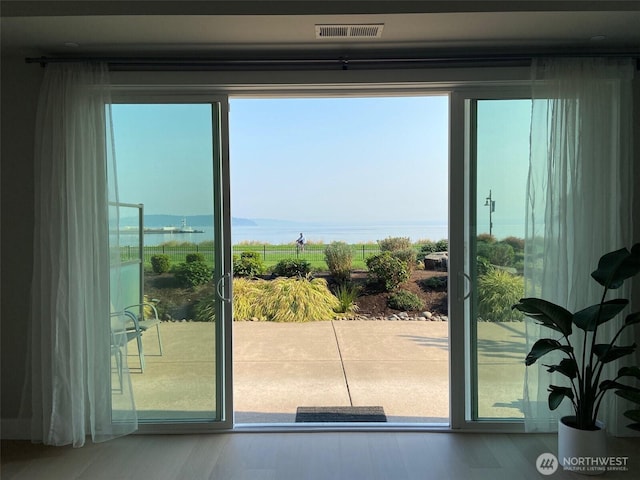 5105 Grand Loop Unit 107, Tacoma, WA 98407 - doorway to outside featuring a water view and wood finished floors