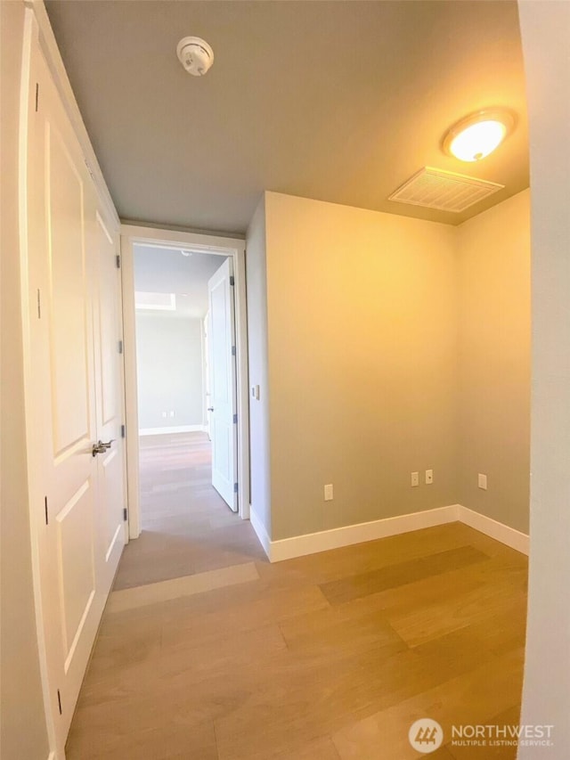 5105 Grand Loop Unit 107, Tacoma, WA 98407 - empty room with wood finished floors, baseboards, and a smoke detector