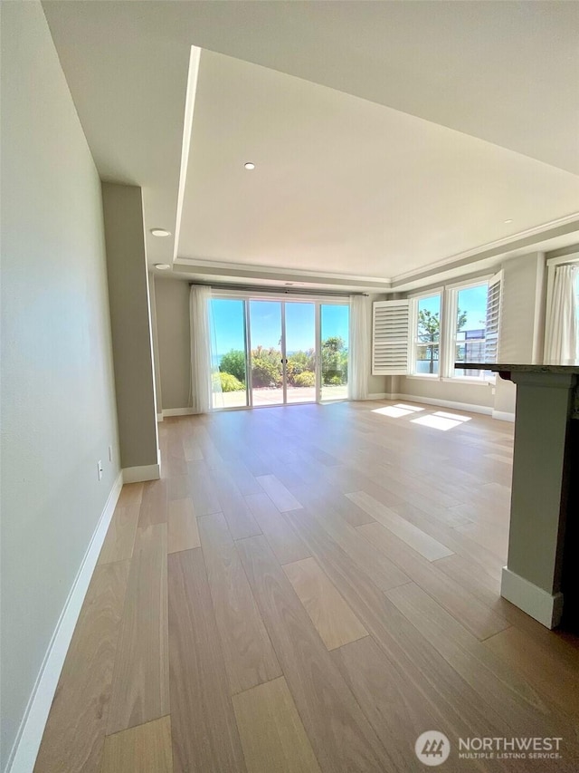 5105 Grand Loop Unit 107, Tacoma, WA 98407 - unfurnished living room with plenty of natural light, baseboards, light wood-style floors, and recessed lighting