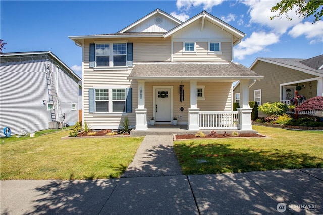 1860 Hoffman Hill Blvd, Dupont, WA 98327 - traditional home with covered porch, a front yard, roof with shingles, and board and batten siding