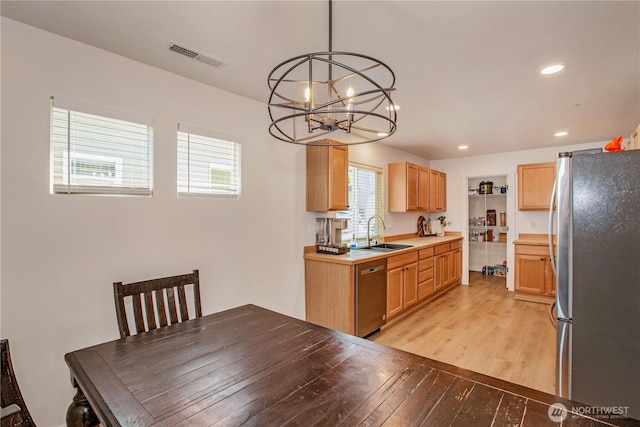 1860 Hoffman Hill Blvd, Dupont, WA 98327 - kitchen with stainless steel appliances, a sink, a chandelier, light wood-style floors, and recessed lighting