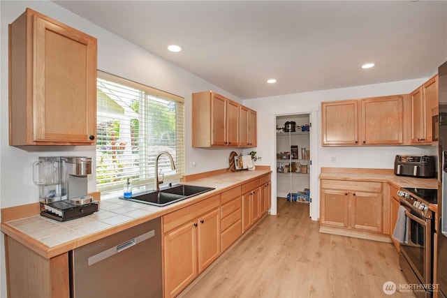 1860 Hoffman Hill Blvd, Dupont, WA 98327 - kitchen featuring a sink, appliances with stainless steel finishes, light wood-style floors, tile countertops, and light brown cabinetry