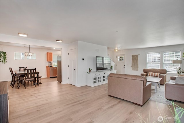 1860 Hoffman Hill Blvd, Dupont, WA 98327 - living area featuring light wood-style flooring, healthy amount of natural light, a chandelier, and baseboards