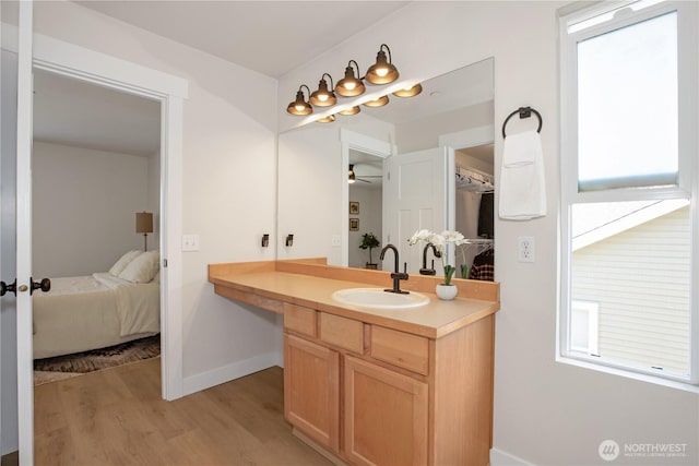 1860 Hoffman Hill Blvd, Dupont, WA 98327 - ensuite bathroom featuring wood finished floors, vanity, ceiling fan, and baseboards