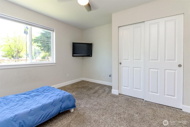181 Coal Ave, Carbonado, WA 98323 - carpeted bedroom featuring baseboards, a closet, and a ceiling fan