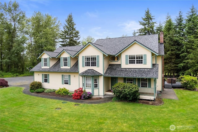 27314 152nd Ave E, Graham, WA 98338 - traditional home featuring a chimney, a porch, a front yard, and roof with shingles