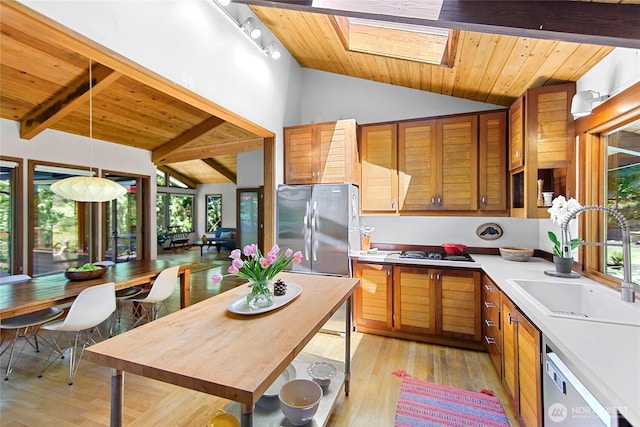 9767 Battle Point Dr NE, Bainbridge Island, WA 98110 - kitchen featuring a wooden ceiling with exposed beams, appliances with stainless steel finishes, light wood-type flooring, light countertops, and decorative light fixtures