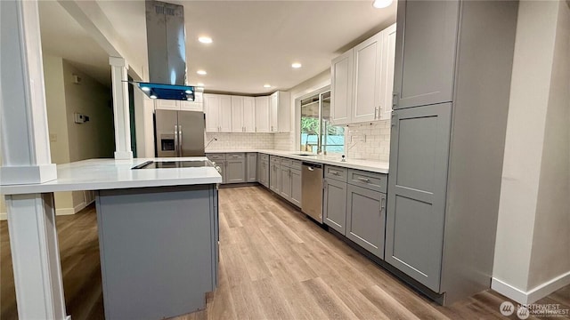 13676 197th Ave SE, Renton, WA 98059 - kitchen featuring gray cabinets, island range hood, stainless steel appliances, decorative backsplash, and light wood finished floors
