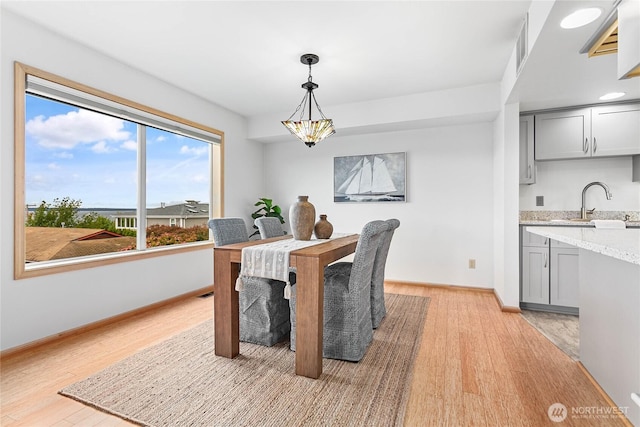 912 11th Unit 101, Bellingham, WA 98225 - dining room with light wood finished floors, baseboards, and a chandelier