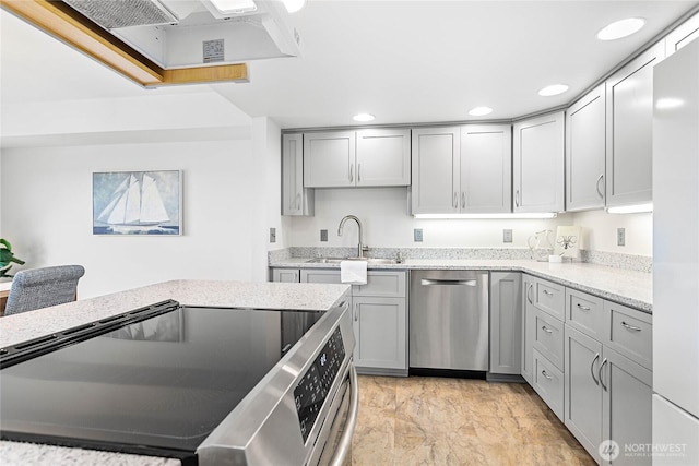 912 11th Unit 101, Bellingham, WA 98225 - kitchen featuring a sink, stainless steel appliances, gray cabinetry, recessed lighting, and light stone countertops