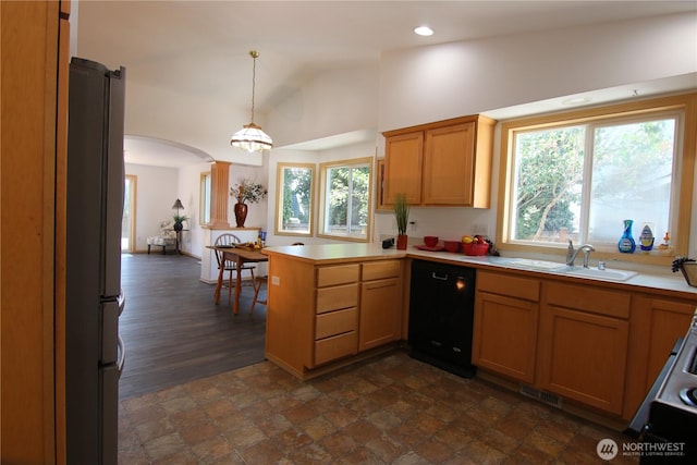 8422 NE 176th St, Arlington, WA 98223 - kitchen featuring dishwasher, a sink, a peninsula, arched walkways, and freestanding refrigerator