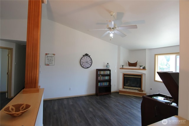 8422 NE 176th St, Arlington, WA 98223 - living area with dark wood finished floors, a glass covered fireplace, ceiling fan, baseboards, and lofted ceiling