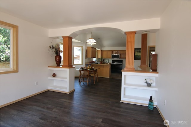8422 NE 176th St, Arlington, WA 98223 - kitchen with stove, stainless steel microwave, ornate columns, brown cabinetry, and dark wood-type flooring