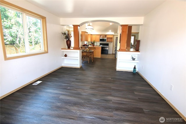 8422 NE 176th St, Arlington, WA 98223 - living area with decorative columns, arched walkways, dark wood-style flooring, and baseboards