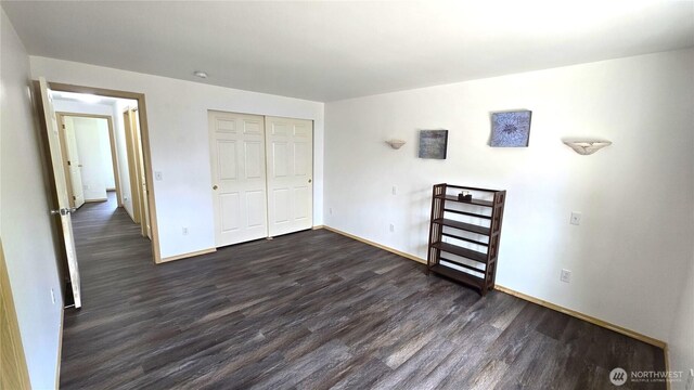 8422 NE 176th St, Arlington, WA 98223 - unfurnished bedroom with dark wood finished floors, baseboards, and a closet