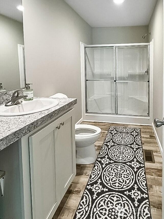 6240 Azure Way, Maple Falls, WA 98266 - full bath with vanity, toilet, a shower with door, wood finished floors, and recessed lighting