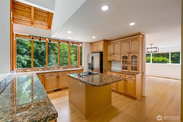 726 114th St NE, Tulalip, WA 98271 - kitchen with stainless steel fridge with ice dispenser, black electric stovetop, recessed lighting, light wood finished floors, and light brown cabinetry