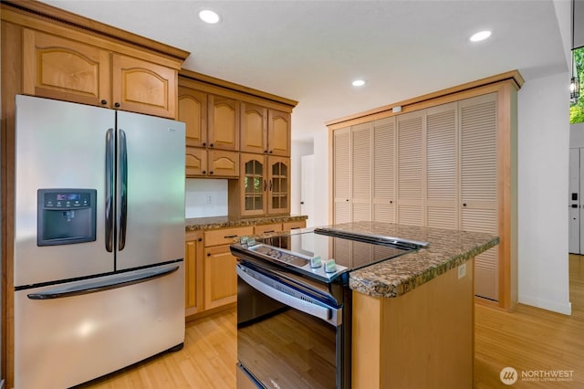 726 114th St NE, Tulalip, WA 98271 - kitchen with appliances with stainless steel finishes, light wood-style floors, recessed lighting, a center island, and glass insert cabinets