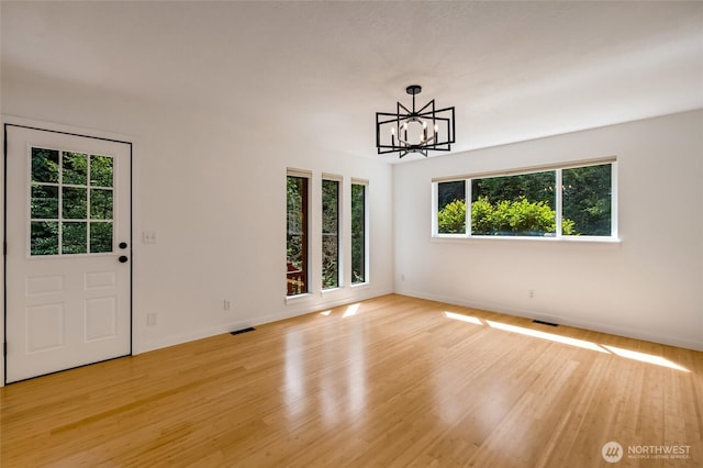 726 114th St NE, Tulalip, WA 98271 - unfurnished dining area with a chandelier and light wood-style floors