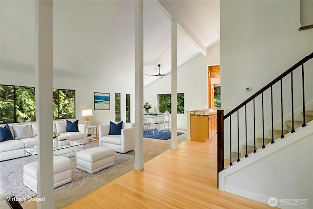 726 114th St NE, Tulalip, WA 98271 - living area featuring healthy amount of natural light, light wood finished floors, beam ceiling, stairs, and high vaulted ceiling