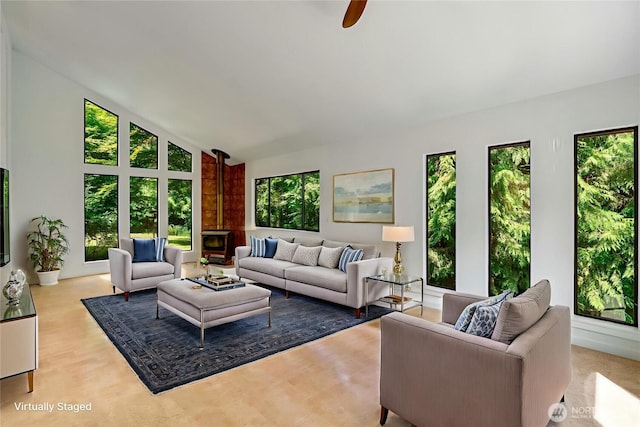 726 114th St NE, Tulalip, WA 98271 - living area featuring a wood stove, high vaulted ceiling, and ceiling fan