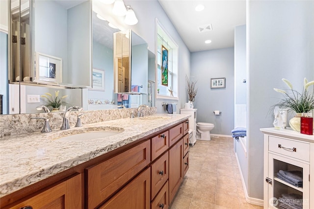 1521 Westview Pl, Lynden, WA 98264 - bathroom featuring double vanity, toilet, a bathtub, baseboards, and recessed lighting