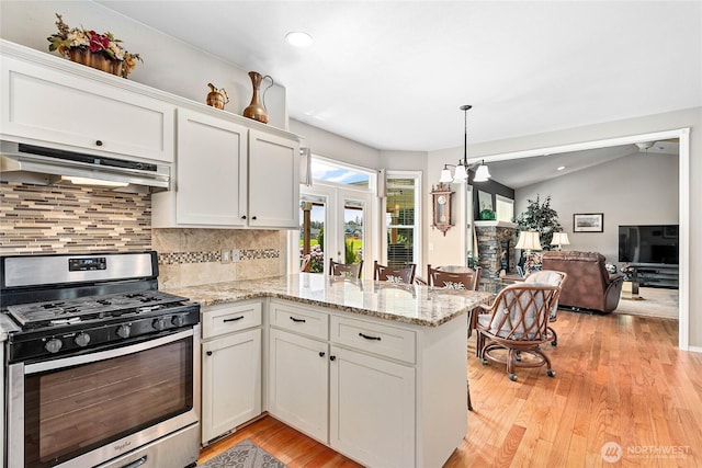 1521 Westview Pl, Lynden, WA 98264 - kitchen with stainless steel range with gas cooktop, under cabinet range hood, a peninsula, white cabinetry, and backsplash