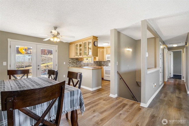 907 S Balsam St, Moses Lake, WA 98837 - dining space featuring french doors, light wood-style floors, a textured ceiling, a ceiling fan, and baseboards