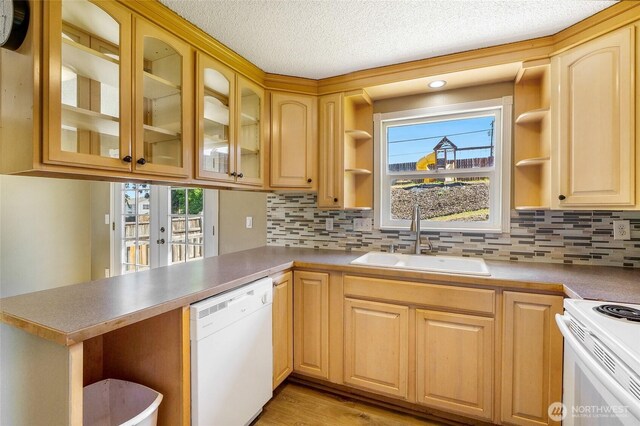 907 S Balsam St, Moses Lake, WA 98837 - kitchen featuring white appliances, open shelves, a sink, a peninsula, and backsplash