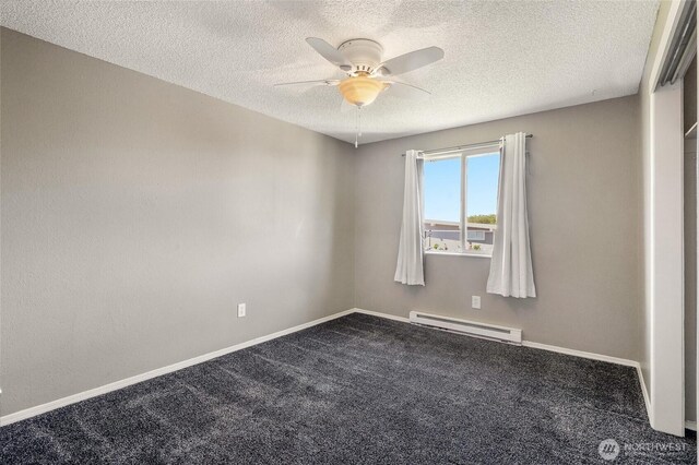 907 S Balsam St, Moses Lake, WA 98837 - empty room with a baseboard heating unit, dark colored carpet, ceiling fan, a textured ceiling, and baseboards