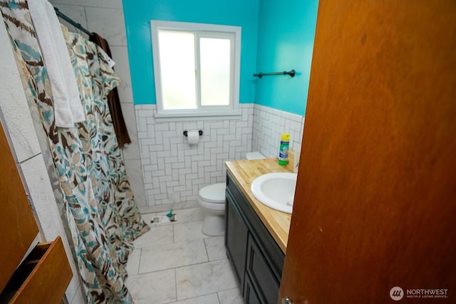 1245 W Axton Rd, Ferndale, WA 98248 - bathroom featuring toilet, vanity, wainscoting, tile walls, and curtained shower