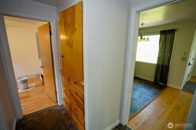 1245 W Axton Rd, Ferndale, WA 98248 - corridor featuring a chandelier, baseboards, and dark wood-style flooring