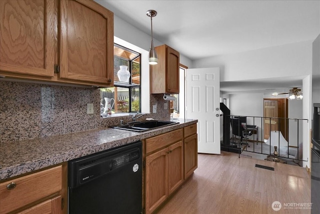 8929 48th Pl W, Mukilteo, WA 98275 - kitchen featuring dishwasher, a sink, light wood-type flooring, brown cabinetry, and dark countertops