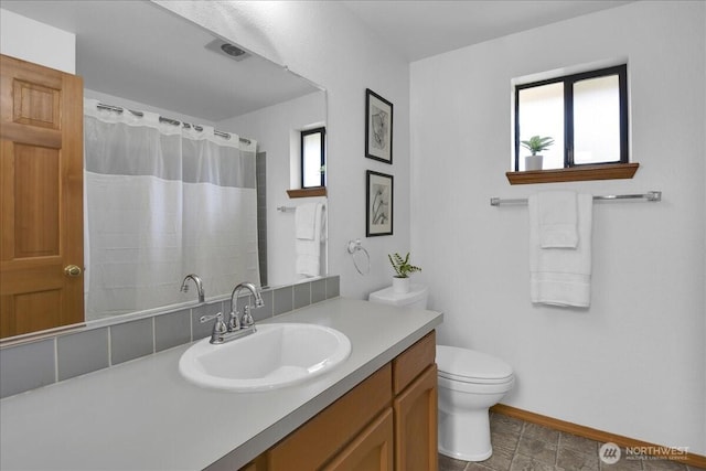 8929 48th Pl W, Mukilteo, WA 98275 - bathroom featuring plenty of natural light, toilet, vanity, and baseboards
