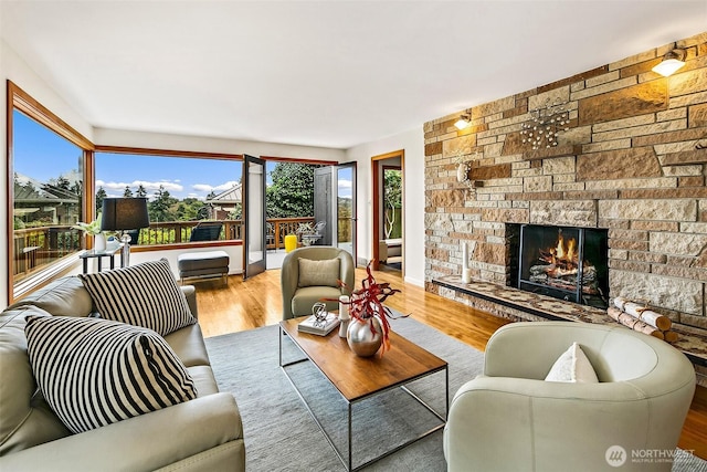 718 N 59th St, Seattle, WA 98103 - living room featuring a fireplace and wood finished floors