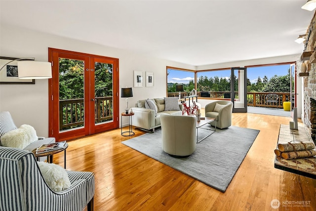 718 N 59th St, Seattle, WA 98103 - living area with french doors, plenty of natural light, and wood finished floors