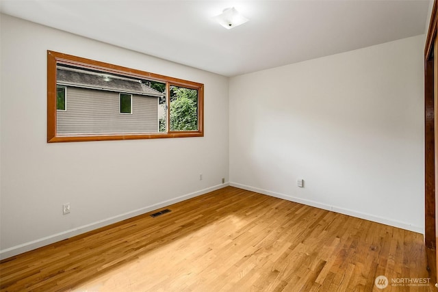 718 N 59th St, Seattle, WA 98103 - unfurnished room with baseboards and light wood-style flooring