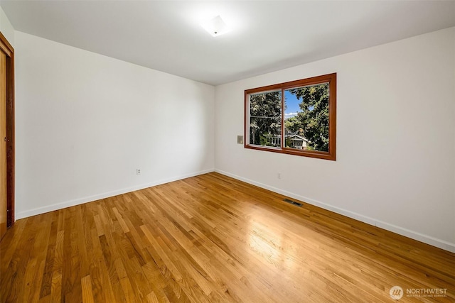 718 N 59th St, Seattle, WA 98103 - spare room with baseboards and light wood-style floors