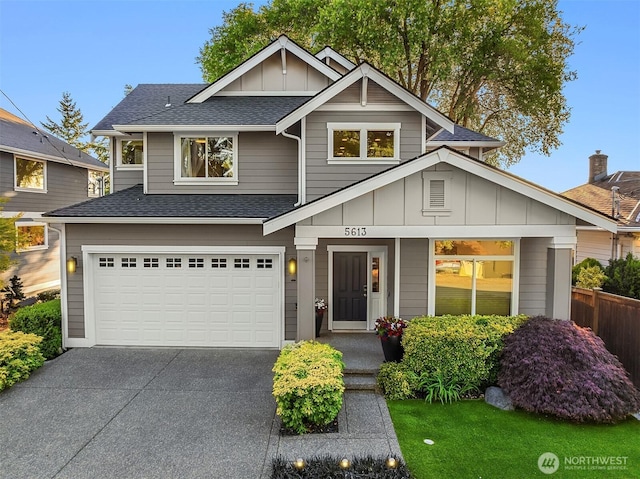 5613 21st Ave SW, Seattle, WA 98106 - view of front of property featuring board and batten siding, a shingled roof, driveway, and a garage