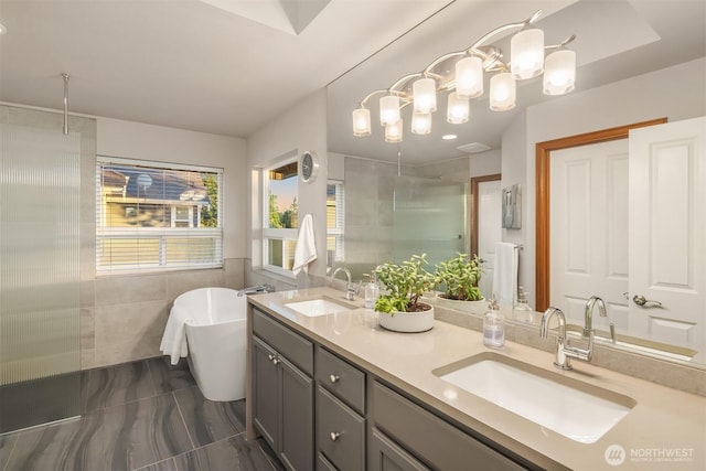 5613 21st Ave SW, Seattle, WA 98106 - bathroom with tiled shower, double vanity, a freestanding tub, tile walls, and a chandelier