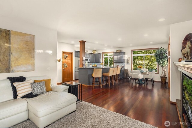 5613 21st Ave SW, Seattle, WA 98106 - living area featuring dark wood-style flooring, recessed lighting, and ornate columns