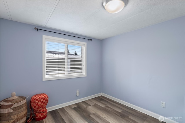1427 100th St SW Unit 145, Everett, WA 98204 - spare room featuring dark wood-style flooring, baseboards, and a textured ceiling