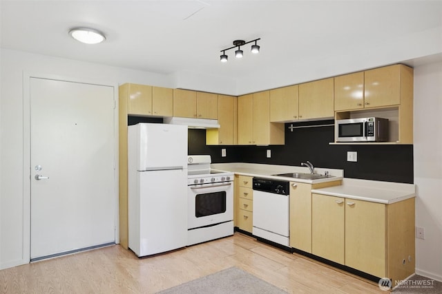 425 Vine St Unit 513, Seattle, WA 98121 - kitchen with white appliances, under cabinet range hood, light brown cabinets, and a sink