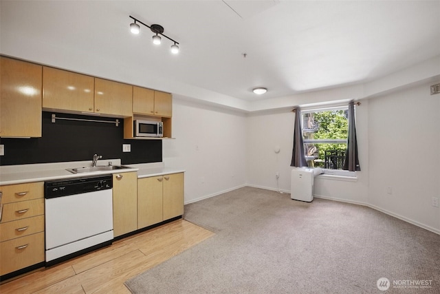 425 Vine St Unit 513, Seattle, WA 98121 - kitchen with white dishwasher, stainless steel microwave, a sink, light countertops, and baseboards