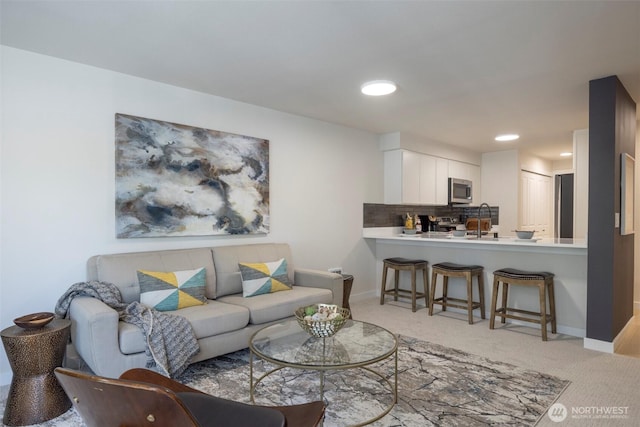 11215 NE 128th St Unit L-203, Kirkland, WA 98034 - living area with light colored carpet, baseboards, and recessed lighting