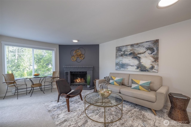 11215 NE 128th St Unit L-203, Kirkland, WA 98034 - living room featuring a fireplace, carpet flooring, and baseboards